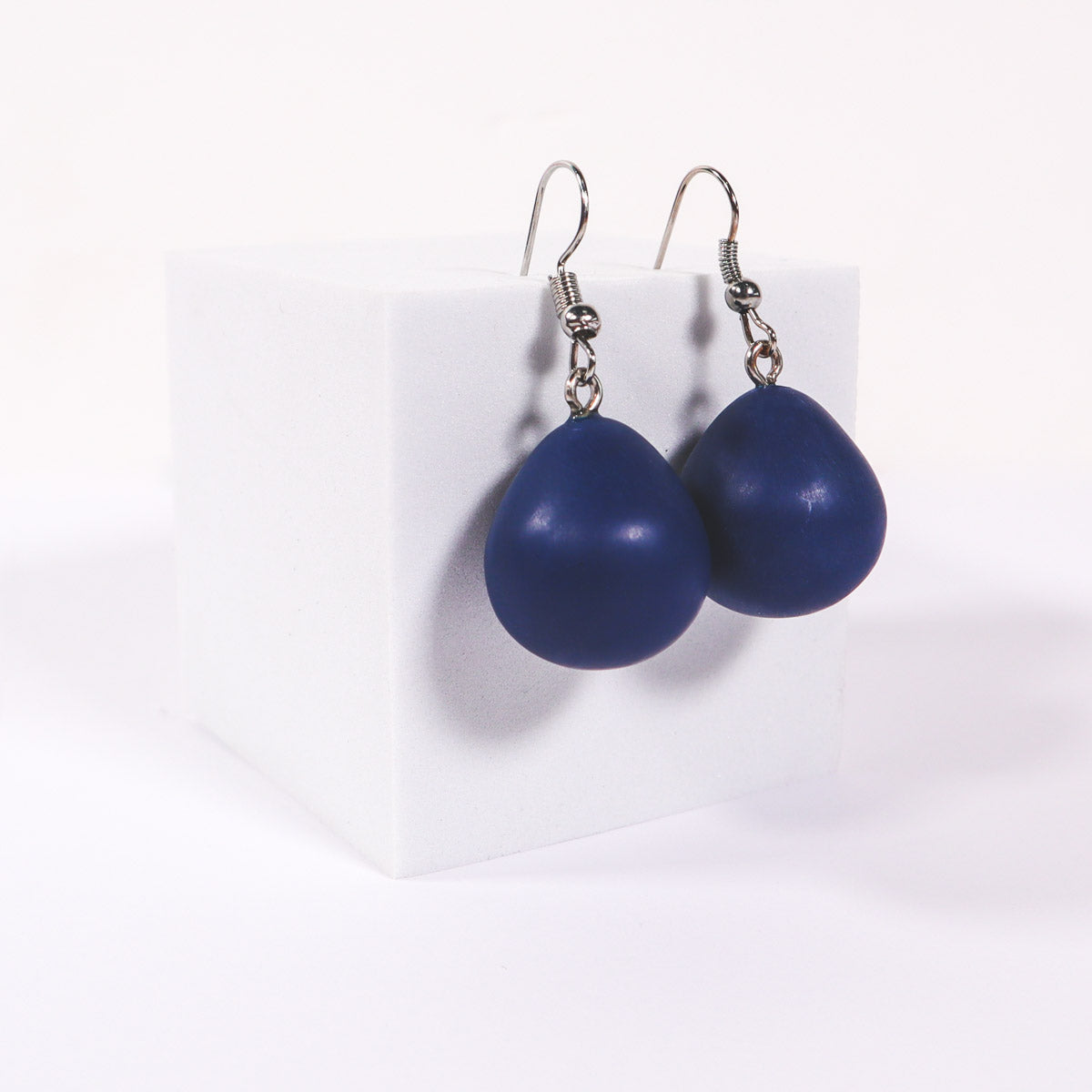 Navy blue everyday drop earrings on a white background.