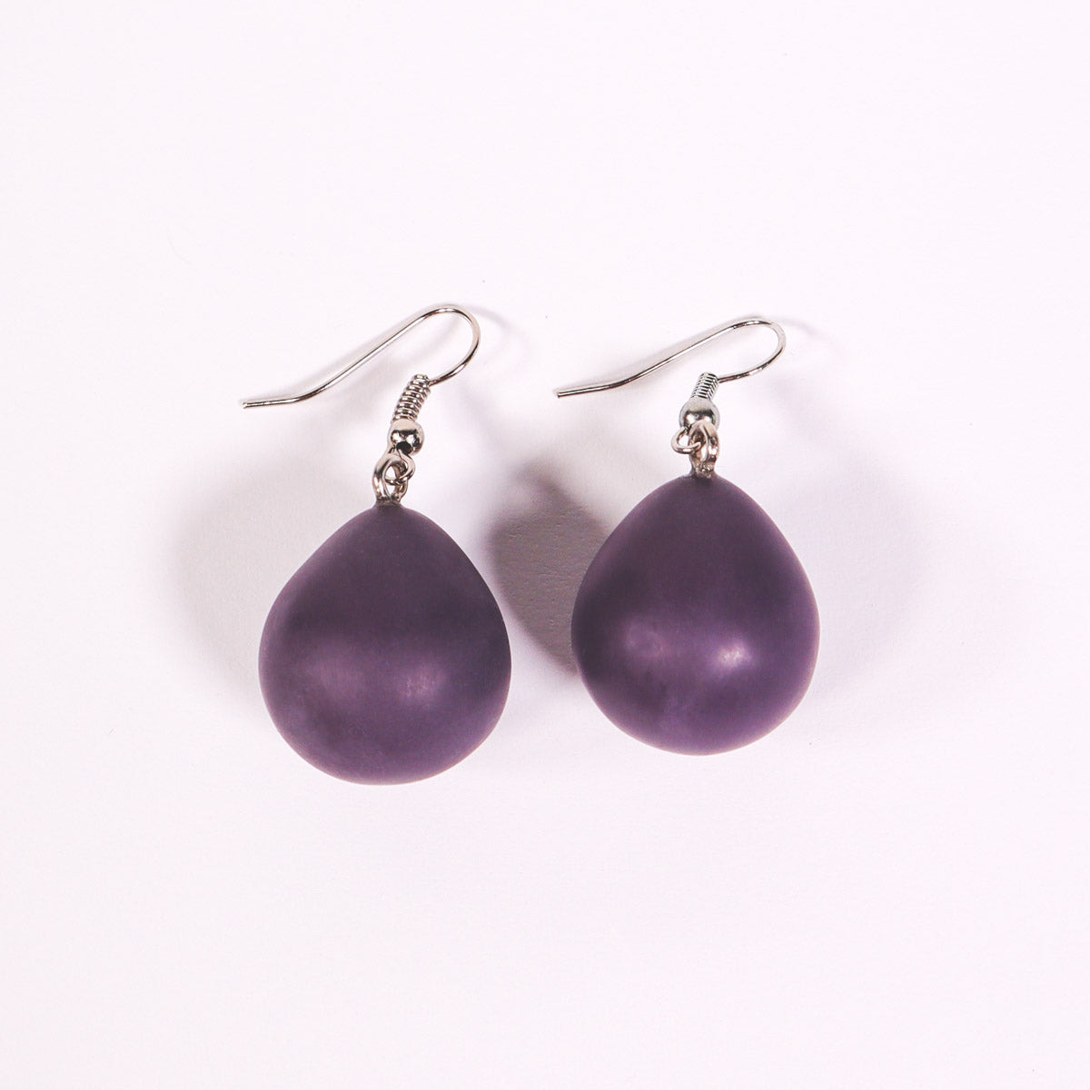 Purple everyday drop earrings on a white background.