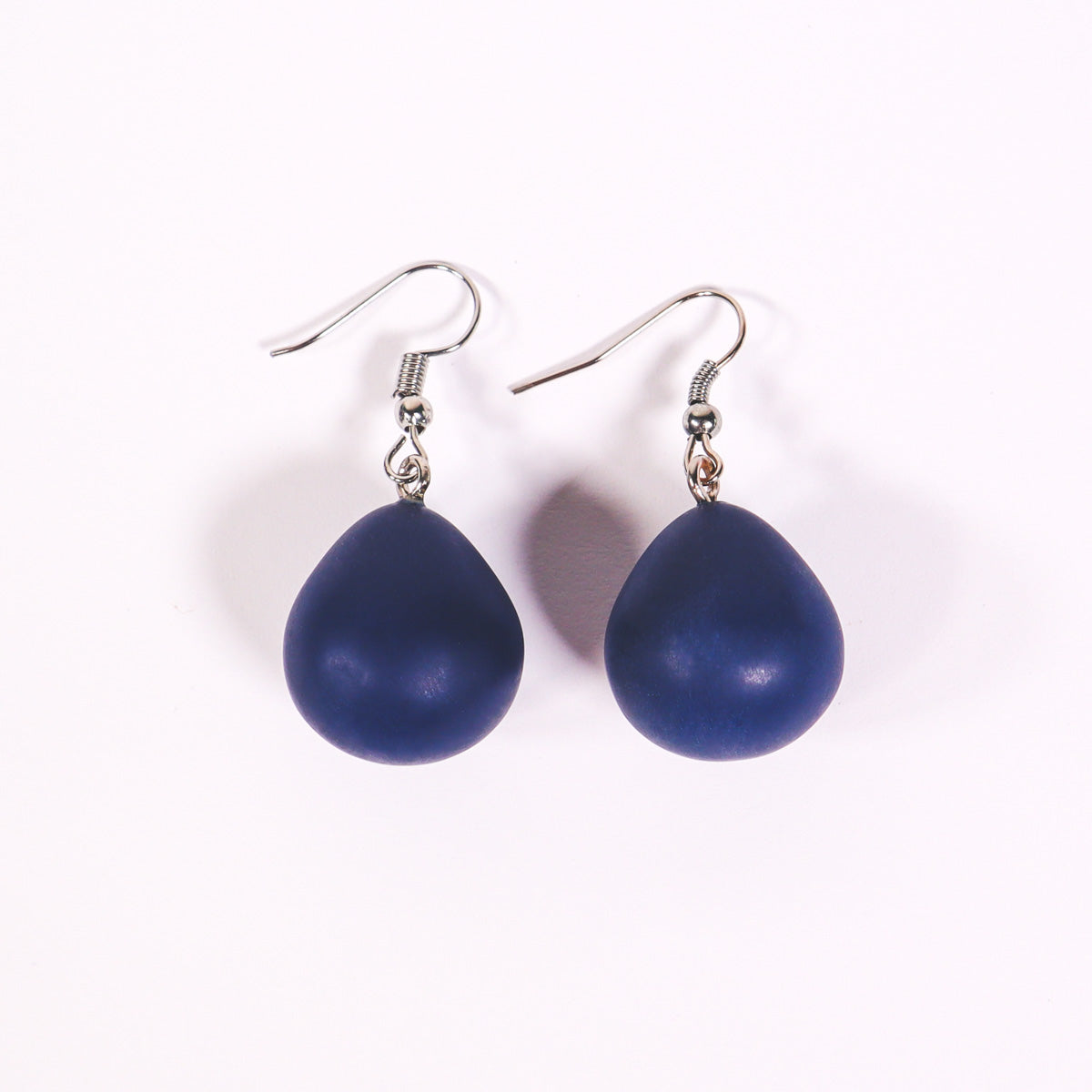 Navy blue everyday drop earrings on a white background.