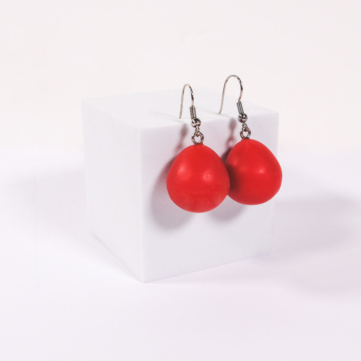 Red matte everyday drop earrings on a white background.