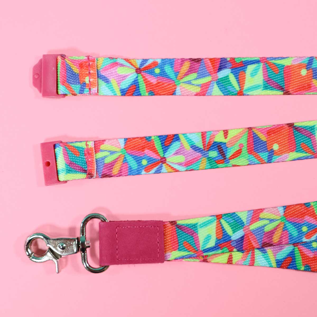 Multi coloured flower patterned lanyard with safety clasp.