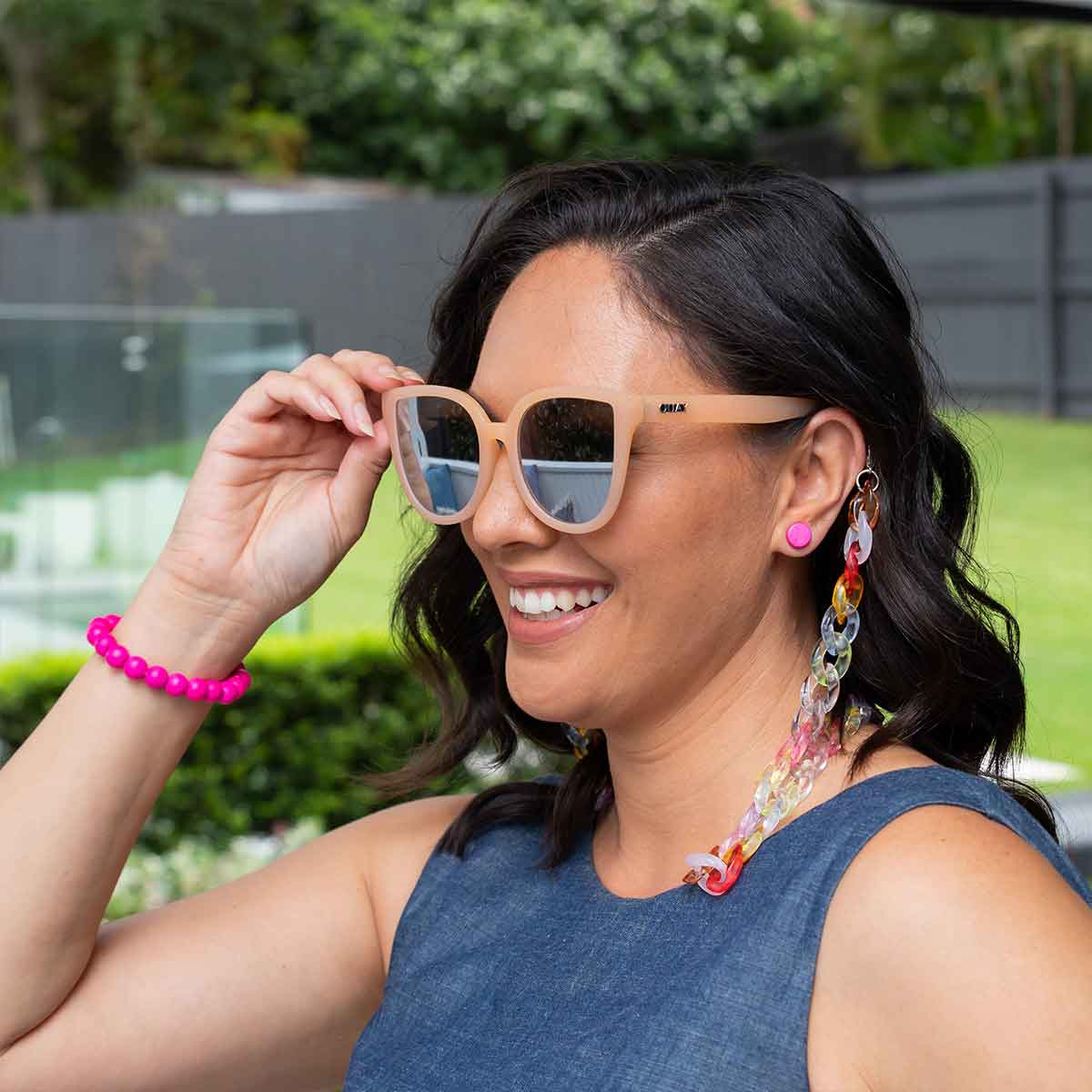 Happy women wearing sunglasses and and funky bright multi coloured jewellery