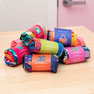 Stack of rolled up colourful Shopping Bags