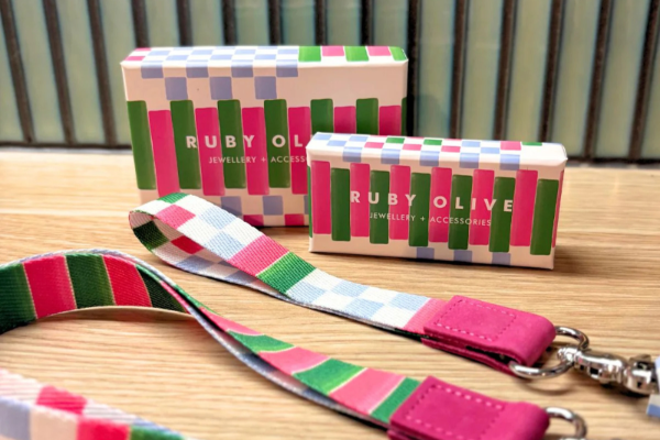 lanyard boxed gift packaging with colorful lanyard and keychain on a wooden surface