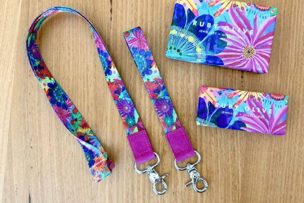 Colorful lanyard and cardholder set on a wooden surface