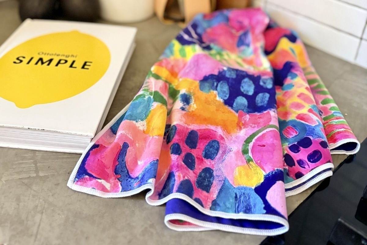 Colorful towel on a surface with a book titled 'SIMPLE' in the background