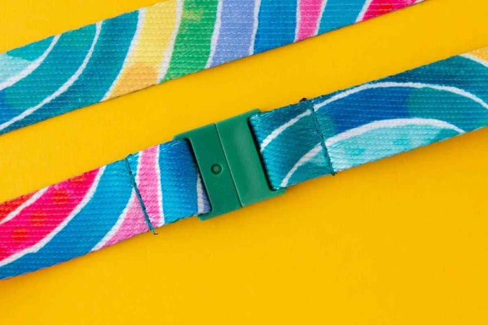 Colorful strap with a green buckle on a yellow background