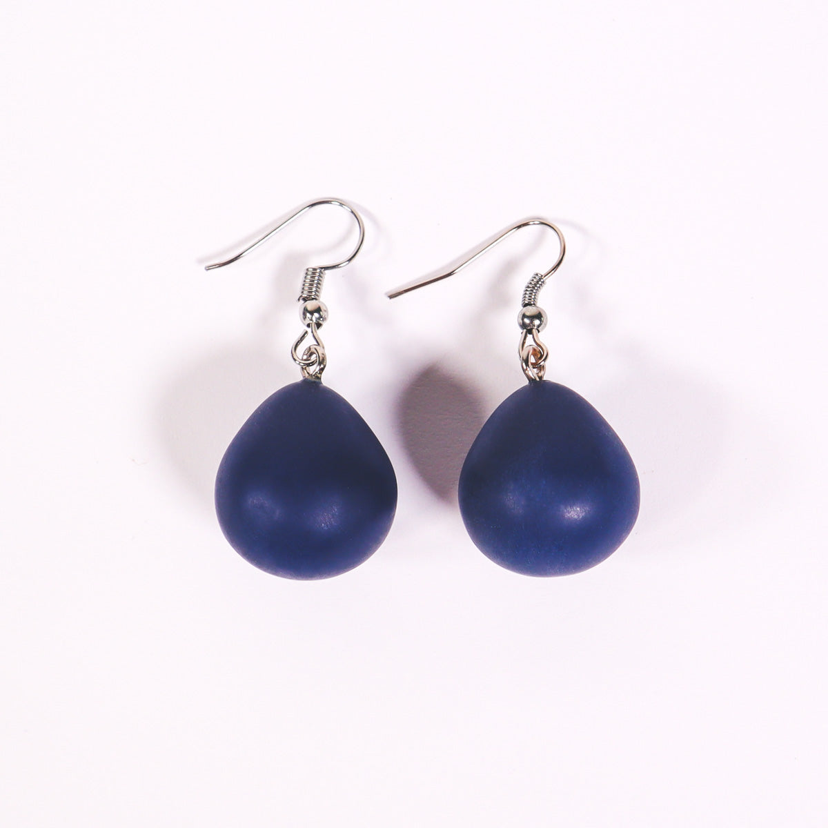 Navy blue everyday drop earrings on a white background. 