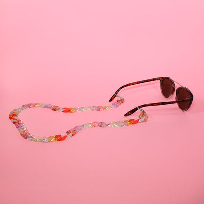 Candy coloured glasses chain with tortoise shell sunglasses.