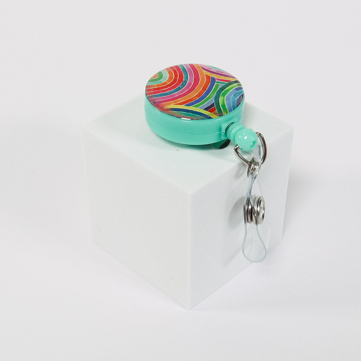 Rainbow badge reel ID holder on a white background.