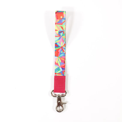 Colourful and bright daisy patterned wrist lanyard on a white background.