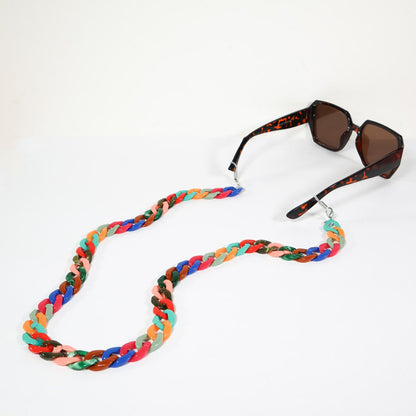 Multi coloured sunglass/ mask chain attached to a tortoise shell sunglasses. 